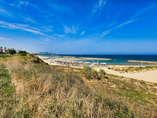 Beautiful landscape of cantabria. Sandy path leading to a beautiful beach with blue water and green grass. Grasses in the dunes overlooking the sea. Beach, island and sea. Seby, beach. La plage.