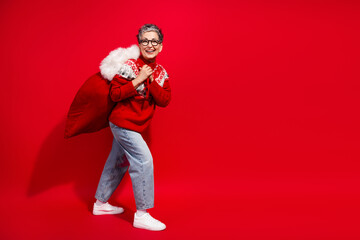 Festive cheer with a stylish woman carrying a red sack and smiling brightly against a vibrant seasonal backdrop
