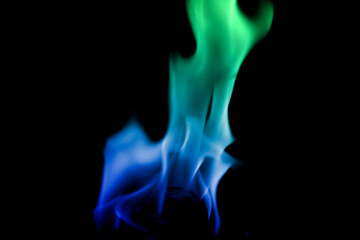 Vibrant Flames in Blue and Green Against Black Background