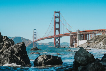 Iconic red Golden Gate Bridge in San Francisco, California. Captured in september at the end of the summer. In front of the bridge lies Marshall's beach.