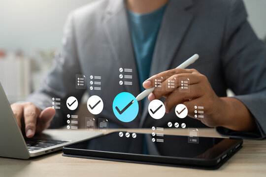 Businessman using digital tablet with checklist icons, planning tasks and managing projects. Concept of productivity, digital workflow, task management, to-do list, and business organization.