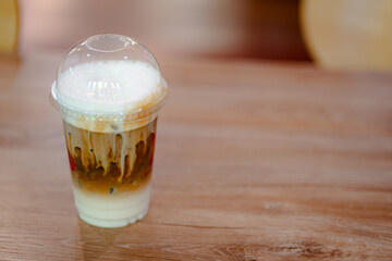 Glasse of iced coffee on table in coffee shop.