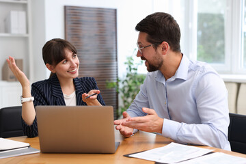Consultant working with client at table in office. Business meeting
