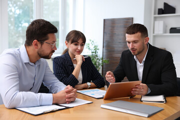 Couple having meeting with business consultant at table in office