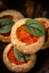 Crispy gourmet shells filled with red caviar.