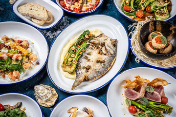 Variety of gourmet seafood and vegetable dishes.