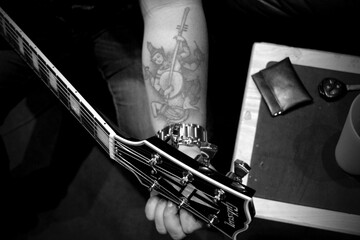 Closeup of guitarist tuning his guitar