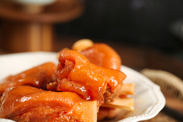 Braised Pork Trotters in Soy Sauce - Traditional Asian Gourmet Delicacy on White Plate