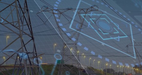 Spanning lattice towers and power lines above highway at dusk with streetlights and digital overlay