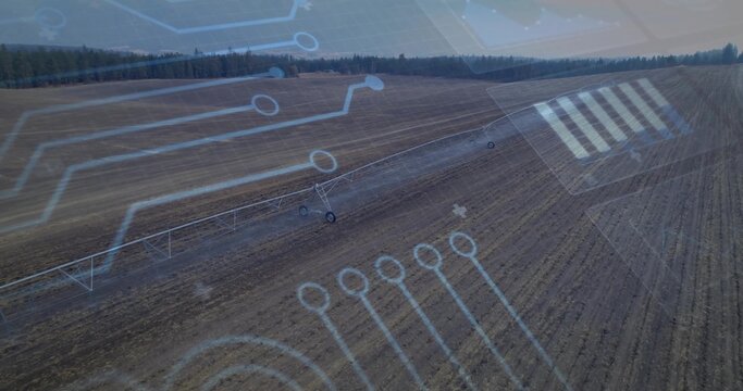 Displaying center pivot irrigation system stretching over farm field, with digital circuit overlays