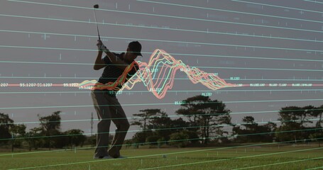 Swinging male golfer hitting ball on tee box, with striped polo, cap, glove and data overlay