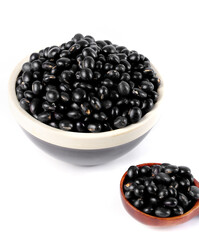Black soy beans in white bowl isolated on white background - healthy legume ingredients