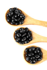 Black Soy Beans and Sesame Seeds in Wooden Spoons on White Background - Healthy Grains and Cooking Ingredients