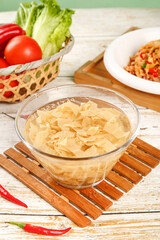 Soy Meat Substitute Products in Glass Bowl with Fresh Vegetables on Rustic Wooden Table