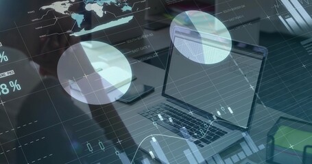 Silver laptop projecting floating charts on office desk, with smartphone binder documents