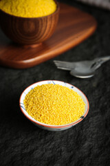 Raw Yellow Millet Grains in Bowl - Nutritious Whole Grain Cereal for Healthy Breakfast