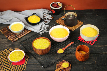 Yellow Millet Porridge and Grains in Wooden Bowls - Traditional Healthy Breakfast Food on Rustic Table