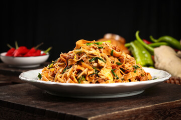 Homestyle Stir-Fried Vermicelli Noodles with Mixed Vegetables and Bean Sprouts on Wooden Table