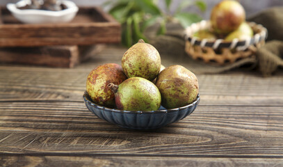 Fresh Camellia Seeds in Bowl - Bountiful Harvest of Oil-Rich Seeds on Rustic Wooden Table