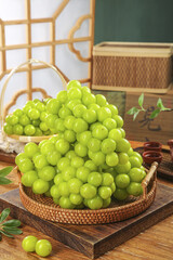Fresh Green Grapes in Wicker Basket on Wooden Table with Natural Sunlight and Traditional Kitchen Decor