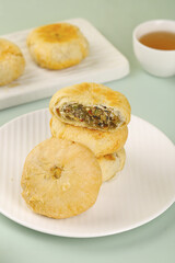 Traditional Chinese Mooncakes with Nut Filling and Crispy Pastry Skin Served with Tea