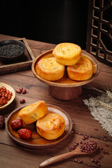 Traditional Chinese Mooncakes with Egg Yolk Mid-Autumn Festival Pastries on Wooden Serving Plates