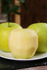 Fresh Dalian Wanglin Apples Peeled and Whole on White Plate with Water Droplets