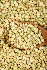 Raw Buckwheat Groats in Wooden Spoon - Healthy Gluten-Free Grain Food Background