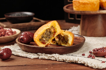 Traditional Chinese Mooncakes with Filling for Mid-Autumn Festival Celebration on Rustic Wooden Background