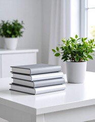 Stack of books, plants, white table