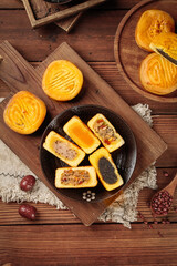 Traditional Chinese Mooncakes Mid-Autumn Festival Pastries with Various Fillings on Rustic Wood