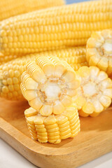 Freshly Picked Sweet Yellow Corn Cobs Cut on Wooden Board