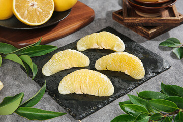 Fresh Taiwan Pomelo Grapefruit Segments on Slate Board with Green Leaves