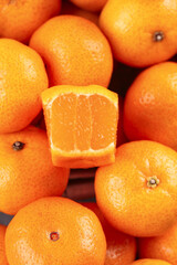 Fresh Ripe Tangerines with Cut Open Fruit Showing Juicy Orange Segments