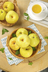 Fresh Asian Pears in Wicker Baskets with Tea Cup on Wooden Table - Healthy Organic Fruit Still Life
