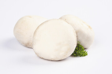 Fresh White Button Mushrooms Sliced and Whole with Green Garnish on White Studio Background