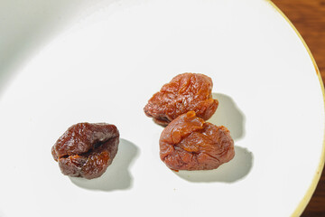 Dried Lychee Fruit from Fujian China on White Plate - Traditional Asian Tropical Snack