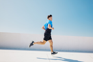 Man running on rooftop during workout session in the city