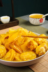 Fish maw soup with chicken and vegetables in traditional Asian bowl with chopsticks and golden broth