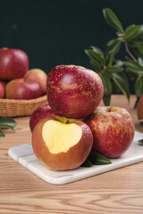 Fresh Red Apples with Heart-Shaped Cut on Wooden Table - Healthy Organic Fruit Display