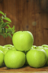 Fresh Green Apples from Shanxi Province China with Water Drops on Rustic Wood Table