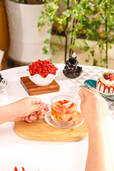 Ningxia Red Wolfberry Goji Berry Tea - Hands Holding Herbal Health Drink with Dried Superfruit