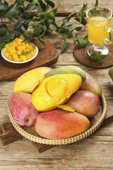 Fresh Ripe Mango Fruits with Juice and Diced Pieces on Rustic Wooden Table