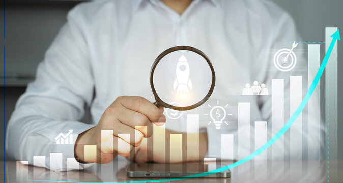 Businessman analyzing growth chart with magnifying glass, data analytics, financial investment, and business success concept.