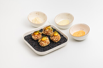 Gourmet quinoa balls with crispy texture and artistic garnish