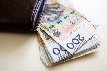 Polish złoty banknotes sticking out of wallet