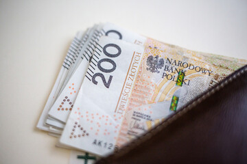 Polish złoty banknotes sticking out of wallet