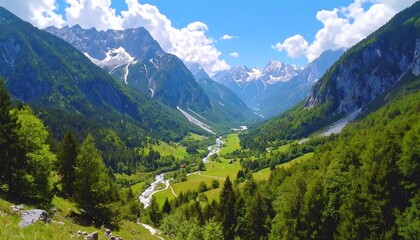 Fototapeta premium Valley view with green mountains and snow capped peaks under a blue, cloud-spotted sky