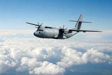 Obraz premium Grey Military Transport Plane Soaring Above Fluffy White Clouds