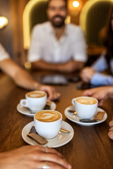 Close-up of a coffee cup on table in modern cafe, cozy and relaxing atmosphere, casual lifestyle moment.